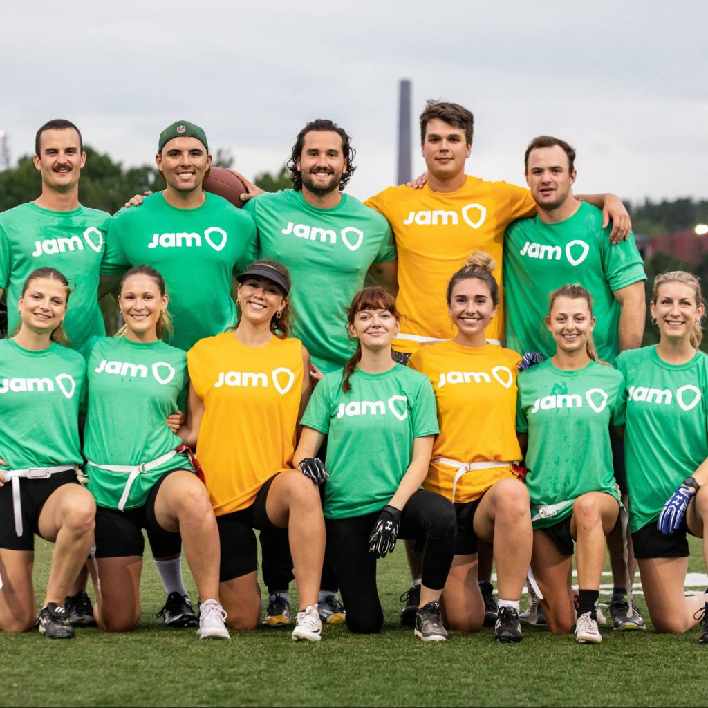 Corporate Soccer Team wearing green and yellow JAM t-shirts