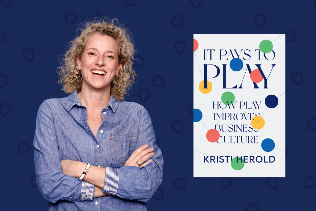 Best-selling author and JAM CEO Kristi Herold in a jean shirt smiling with her book cover "It Pays to Play - How Play Improves business Culture" 